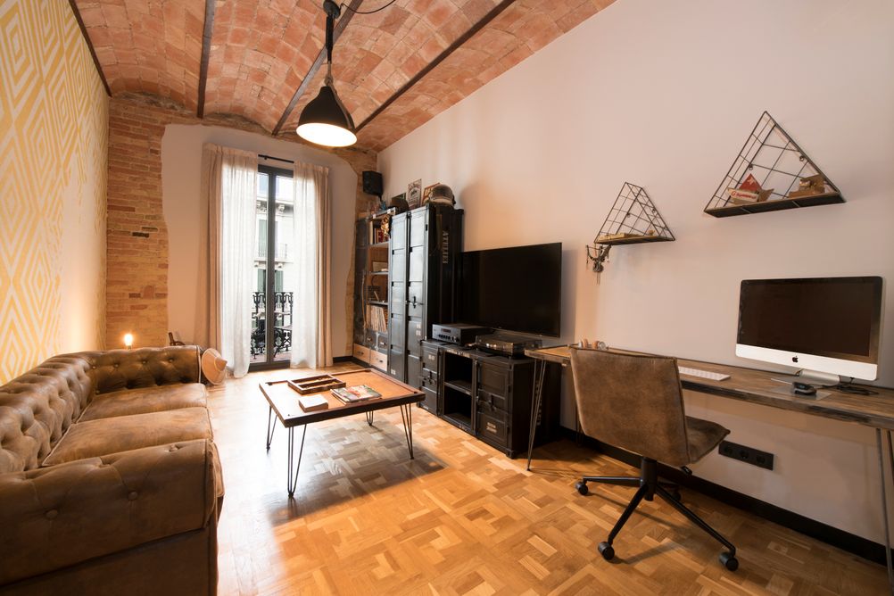 Zona de estudio con mobiliario industrial. Techo bóveda catalana y suelo de parquet natural restaurado.