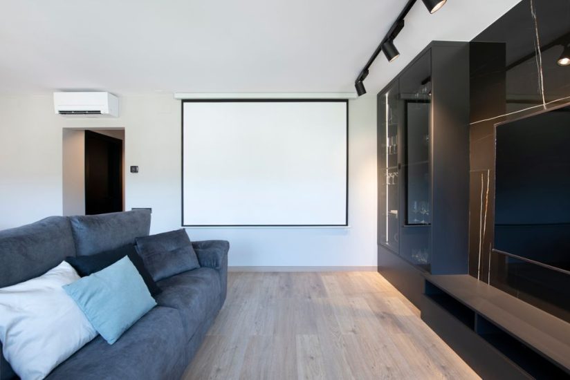 Pantalla enrotllable per projector a una paret del saló
