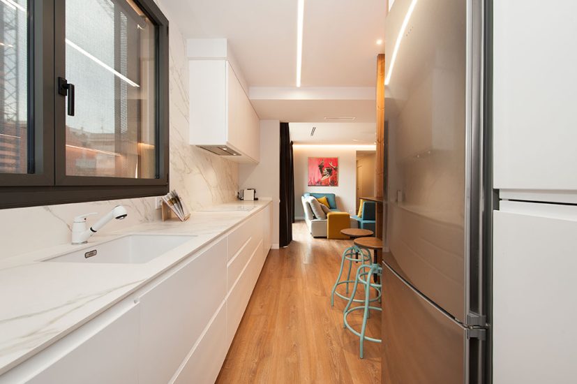 Cocina blanco con mármol abierta al salón.